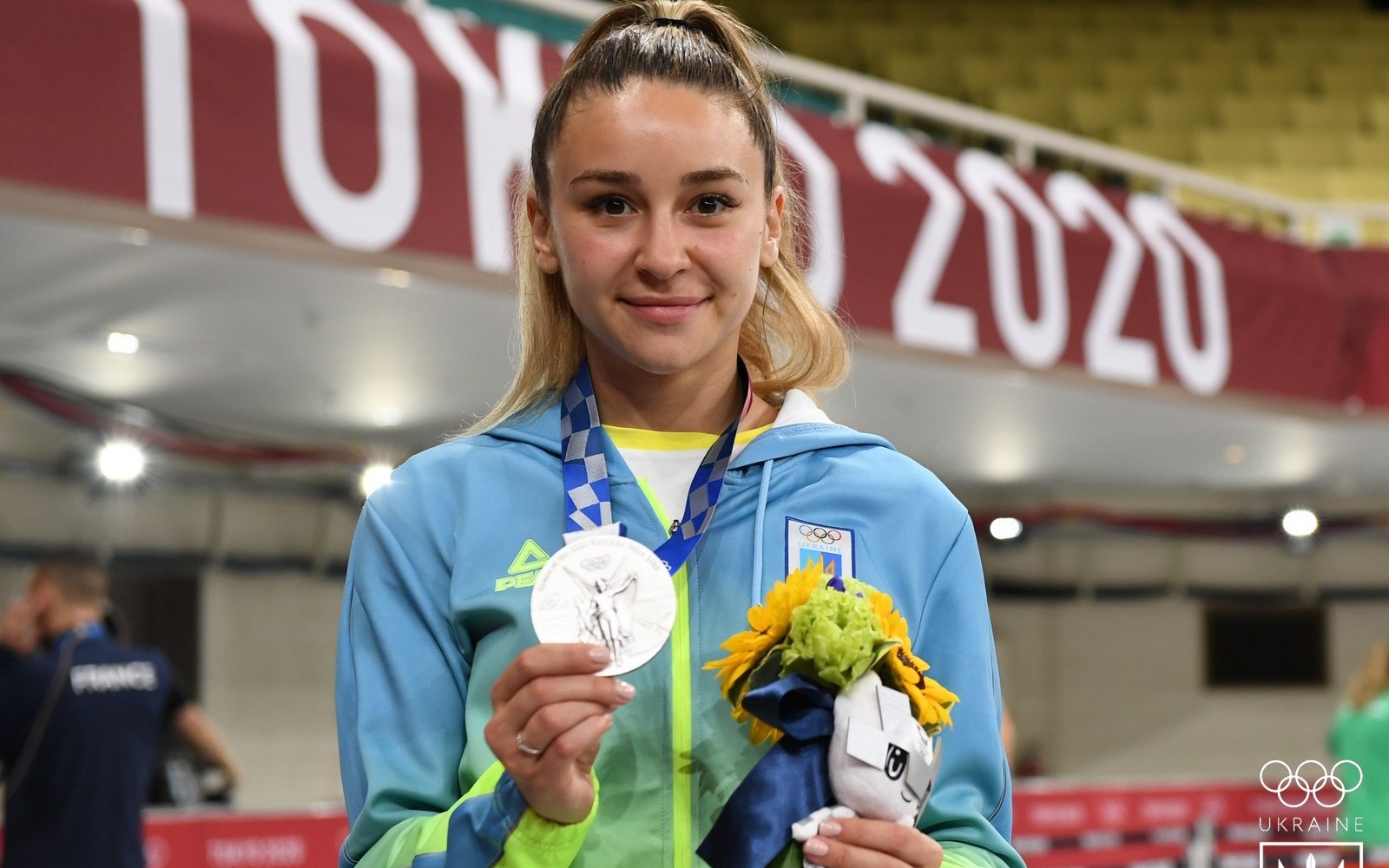 Ukrainian athlete holds up a silver medal and mascot toy at the Tokyo 2020 Olympics